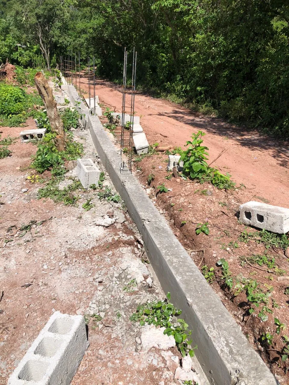 A masonry mesh fence being built around the City of Refuge campus
